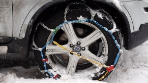 A set of snow chains necessary for travel put on a tire.
