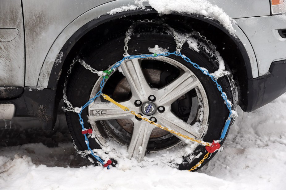 A set of snow chains necessary for travel put on a tire.
