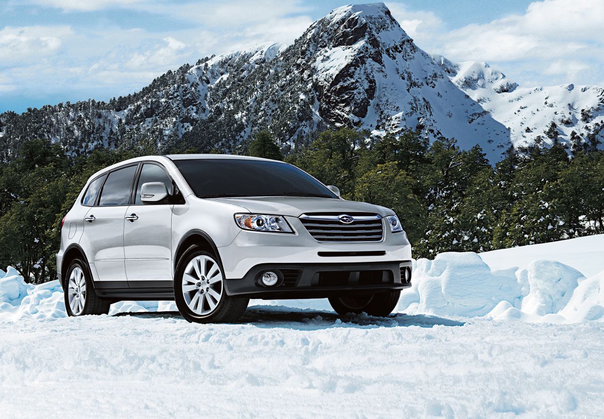 A Subaru Tribeca on display against a snowy backdrop.