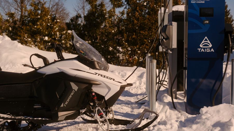A Taiga electric snowmobile plugged into a charging station in Saint-Paulin, Quebec, Canada