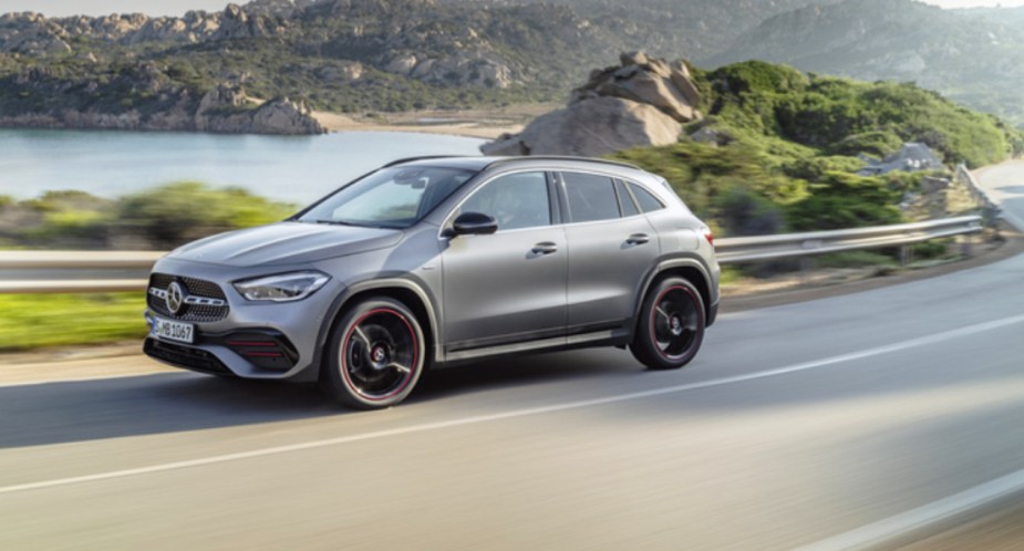A gray 2019 Mercedes-Benz GLA-Class subcompact luxury SUV is driving on the road. 