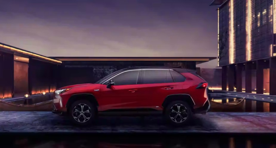 A red Toyota RAV4 Prime small plug-in hybrid SUV is parked. 