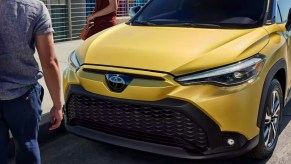 The front of a gold 2023 Toyota Corolla Cross Hybrid.