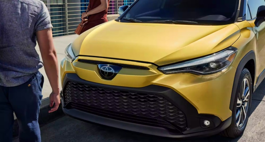 The front of a gold 2023 Toyota Corolla Cross Hybrid subcompact hybrid SUV.