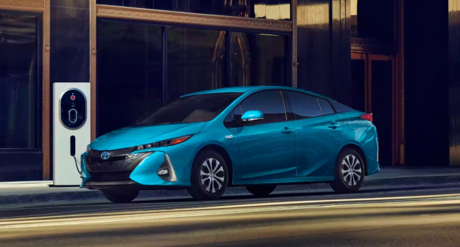 A blue 2022 Toyota Prius Prime is parked and charging. 