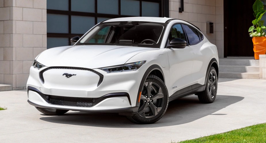A white 2023 Ford Mustang Mach-E small electric SUV is parked. 