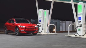 A red 2023 Ford Mustang Mach-E is charging.