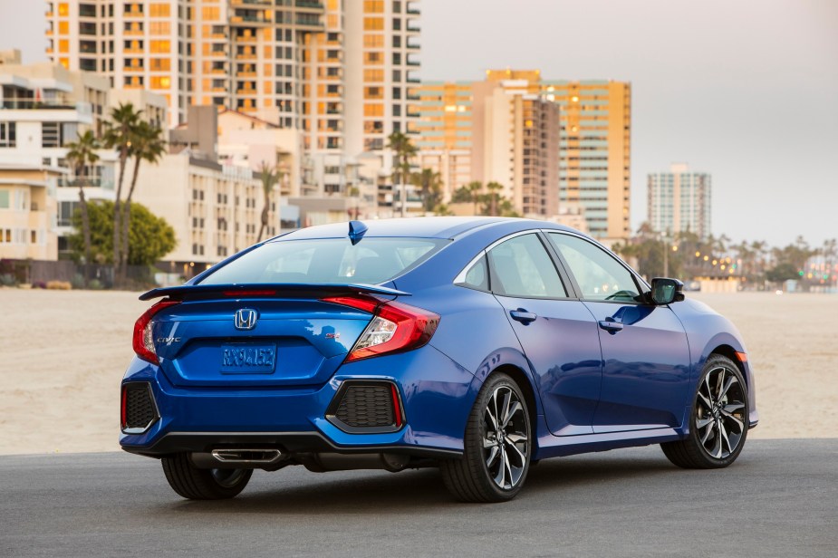 A used Honda Civic shows off its four-door car styling on a beach. 