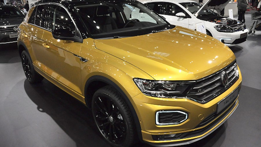 A gold Volkswagen T-Roc as one of the most reliable Volkswagen models parked indoors.