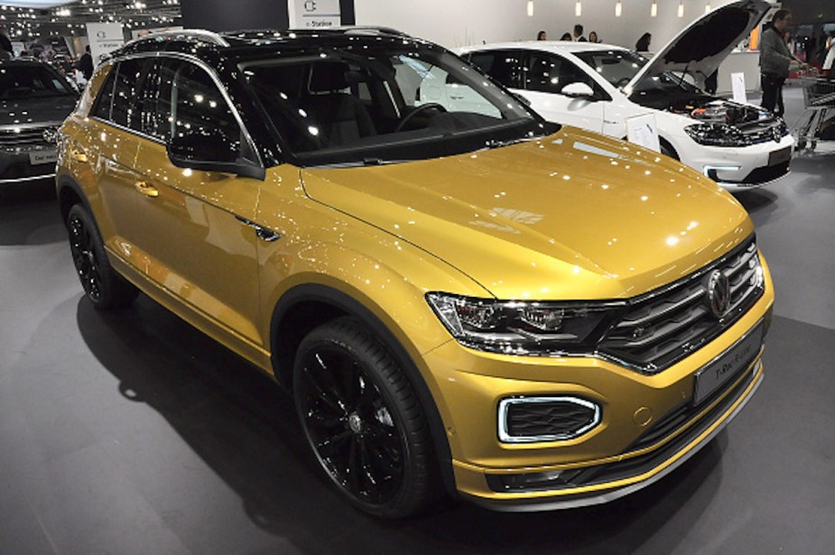 A gold Volkswagen T-Roc as one of the most reliable Volkswagen models parked indoors. 