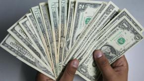 A man holding a wad of cash.