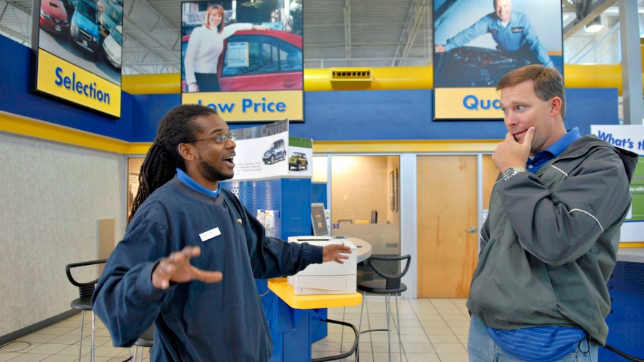 A CarMax sales person talks to a customer