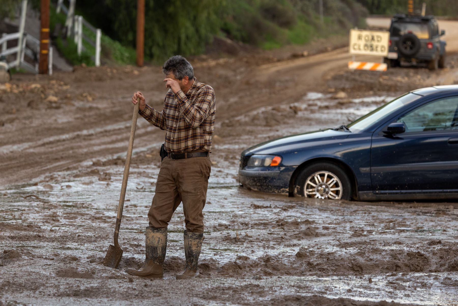 Cars stuck in wet mud after flooding in the town of Piru, near Fillmore, California