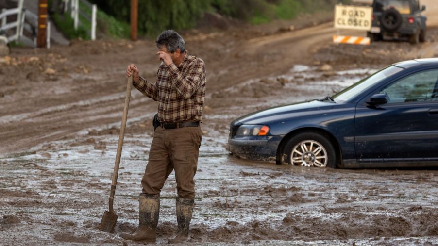Cars stuck in wet mud after flooding in the town of Piru, near Fillmore, California