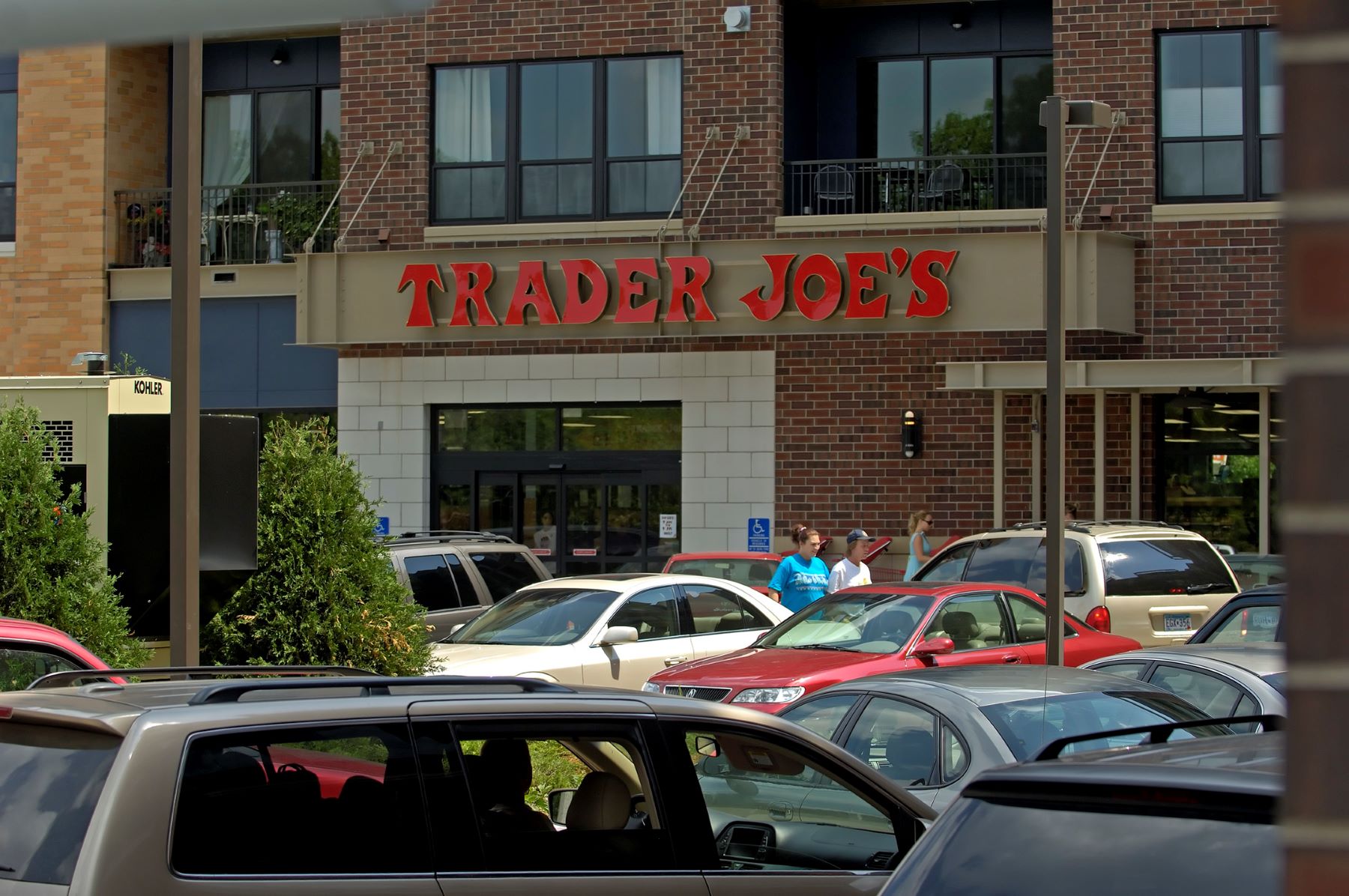 A Trader Joe's rear parking lot filled with cars in St. Louis Park, Minnesota