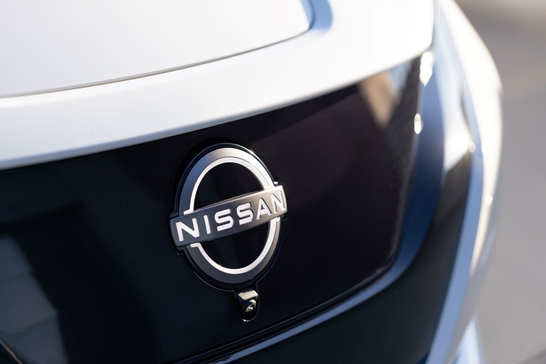 An illuminated Nissan logo on the 2023 Nissan Leaf all-electric hatchback model