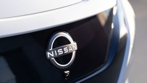 An illuminated Nissan logo on the 2023 Nissan Leaf all-electric hatchback model