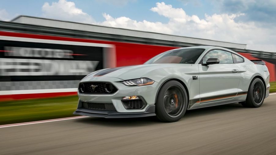 A 2023 Ford Mustang muscle car racing on a motor speedway