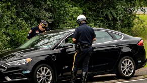 Highway patrol officers pull a car over.