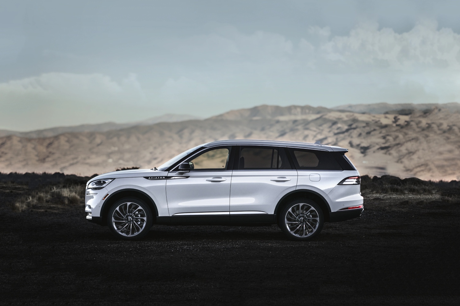 Spacious midsize luxury SUVs like this 2023 Lincoln Aviator parked in front of a mountain