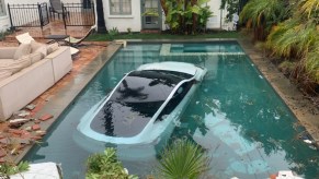 A Tesla vehicle is submerged in a swimming pool.