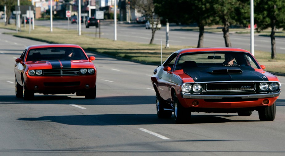 A new (2006) Dodge Challenger concept car and an original 1970 Dodge Challenger cruise together down a Detroit road.