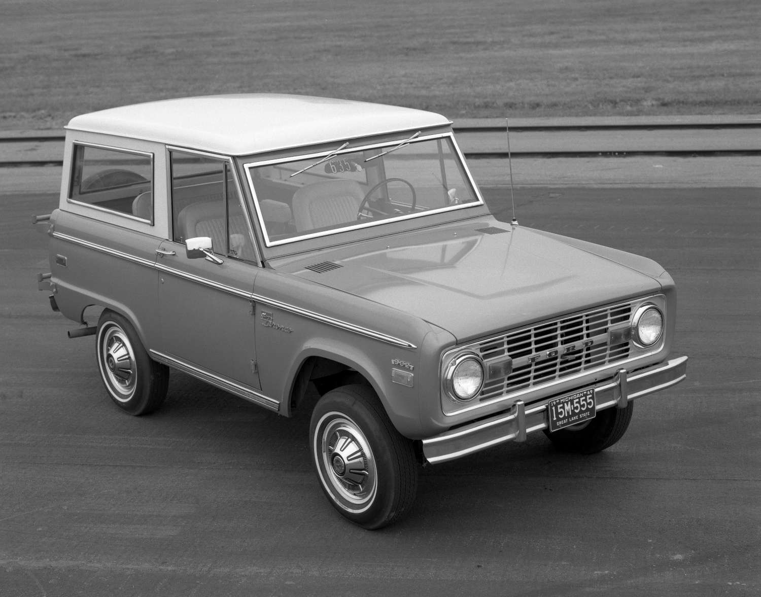 A 1970 Ford Bronco with a white roof