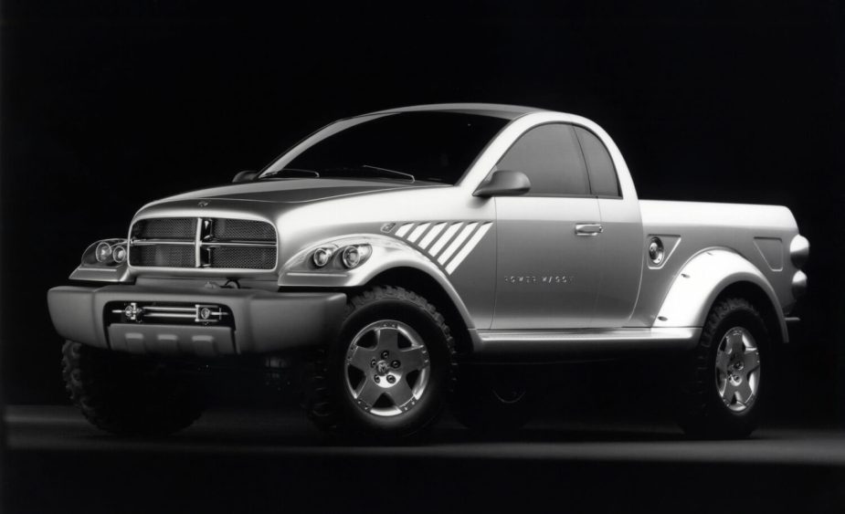 Silver Power Wagon retro concept pickup truck by Dodge Ram parked in front of a black backdrop for a promo photo. 