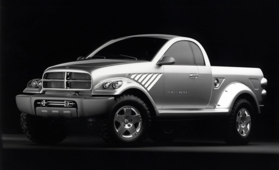 Silver Power Wagon retro concept pickup truck by Dodge Ram parked in front of a black backdrop for a promo photo.