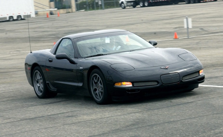 A 2004 Chevrolet Corvette Z06 drives around a lot while it shows off its cheap fast sports car styling and black paintwork. 