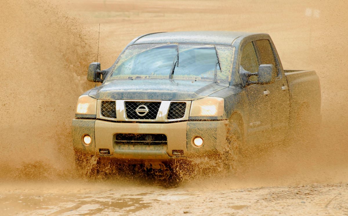 A 2006 Nissan Titan drives through mud.