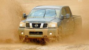 A 2006 Nissan Titan drives through mud