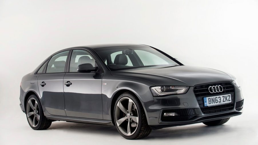 A used gray 2013 Audi A4 shows off its small car proportions and sleek LED lights.