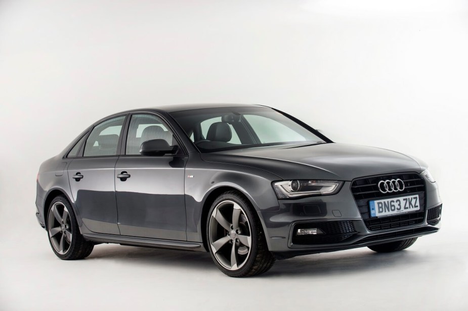A used gray 2013 Audi A4 shows off its small car proportions and sleek LED lights.