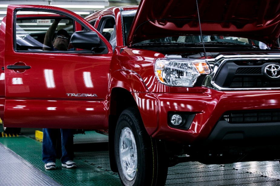 A red 2013 Tacoma is on the assembly line. 