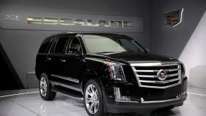 A black 2015 Cadillac Escalade parked indoors.