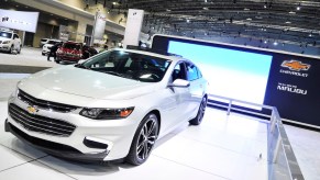 A white 2016 Chevy Malibu parked indoors.