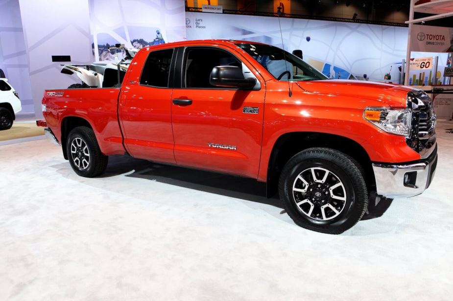 A bright orange 2017 Toyota Tundra on display at an auto show.
