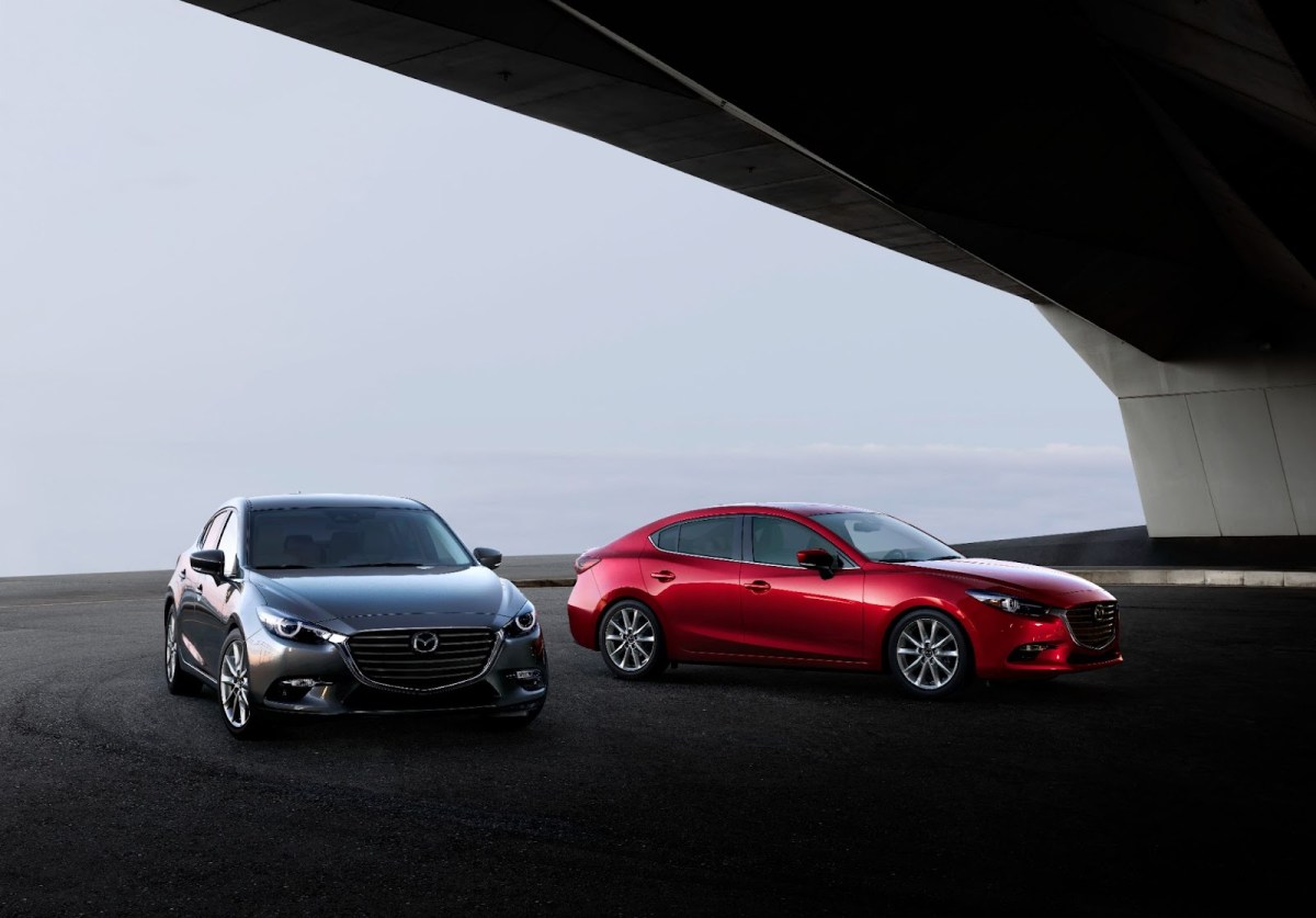 A gray Mazda3 hatchback and red Mazda3 sedan