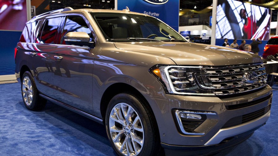A gold 2018 Ford Expedition parked indoors.