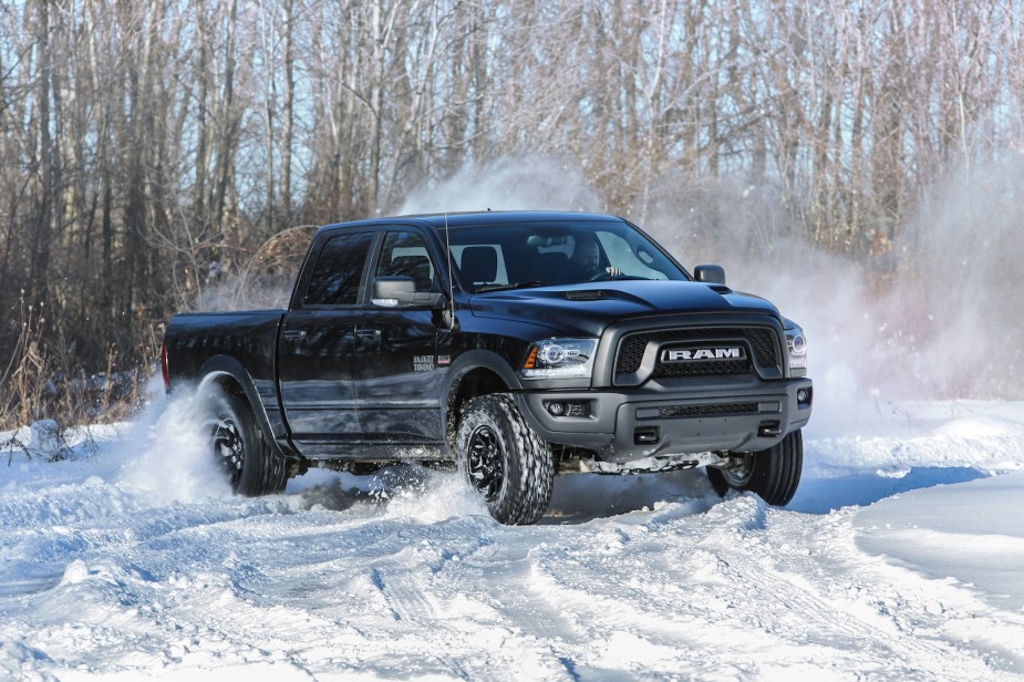 Promo photo of a Ram 1500 pickup truck skidding across snow-covered ground, trees visible in the background.