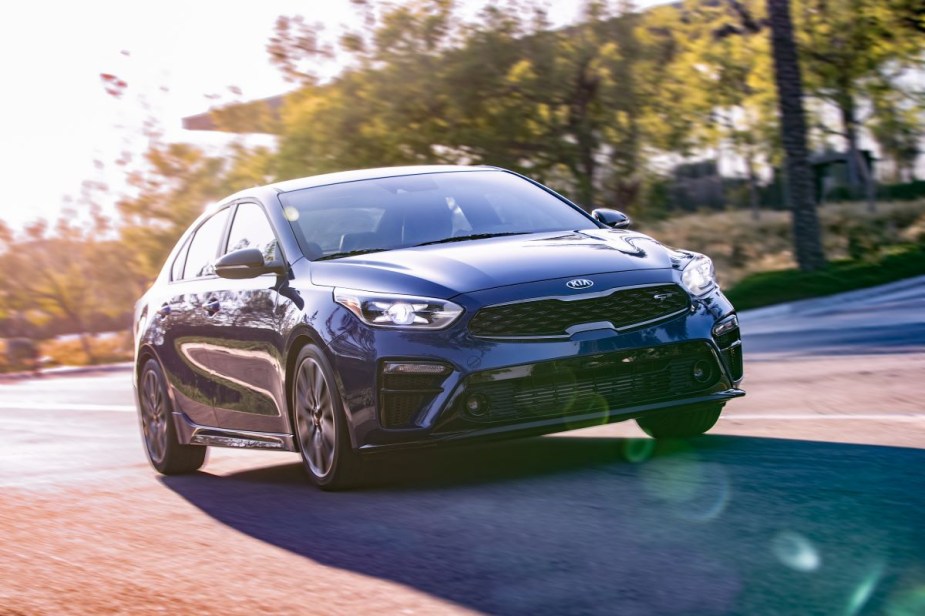 A blue 2020 Kia Forte driving down the road