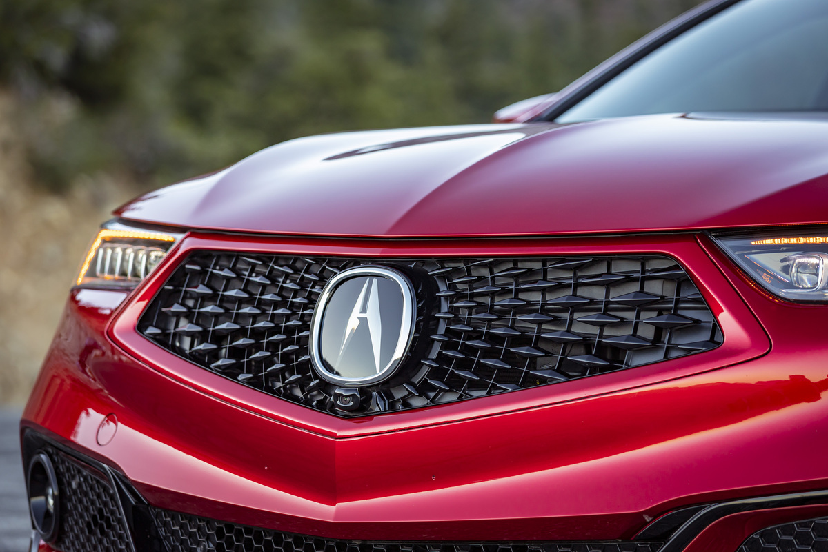 The front grille of a red 2020 Acura TLX.