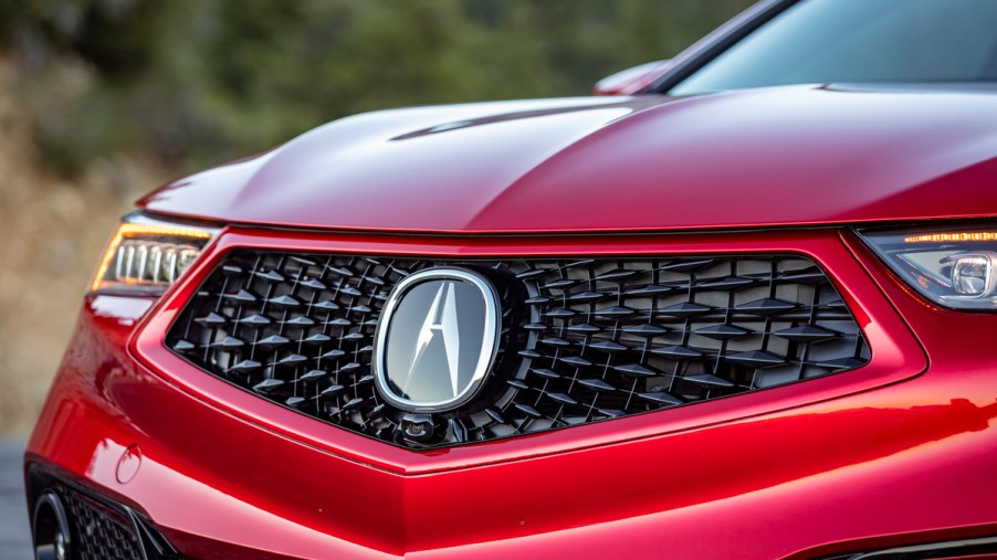 The front grille of a red 2020 Acura TLX.