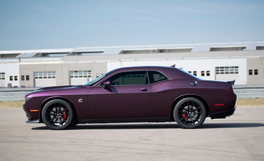 A 2023 Dodge Challenger R/T Scat Pack shows off its muscle car side profile and purple paintwork. 