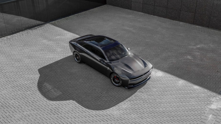 Bird's eye view of Dodge SRT's electric Charger prototype parked on a cobblestone courtyard.