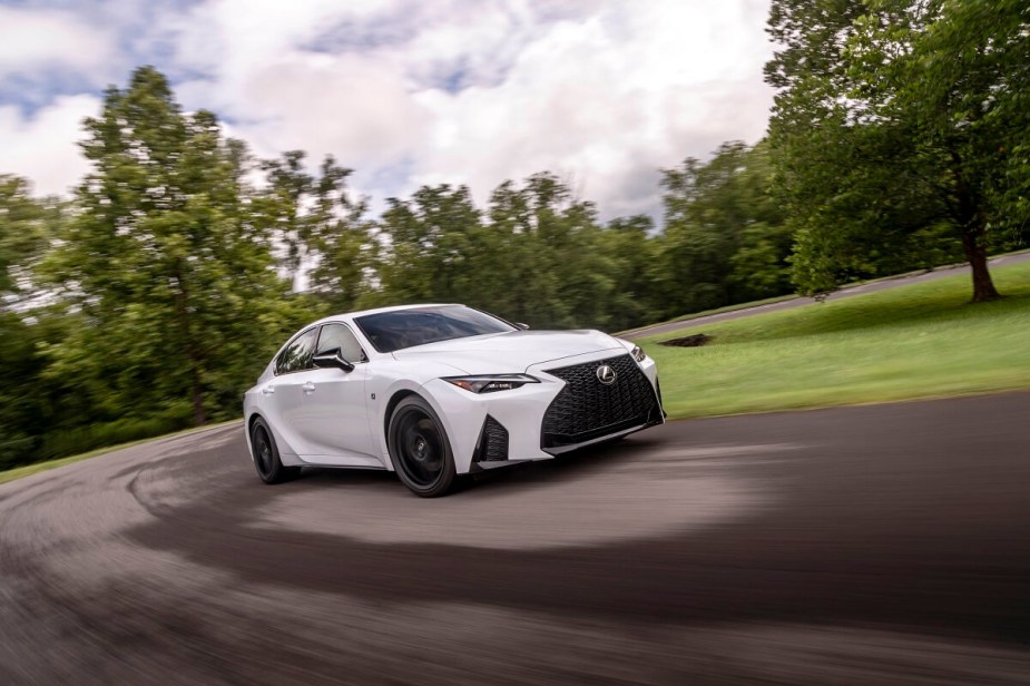 A new white 2023 Lexus IS 350 blasts around a corner faster than an IS 300 could.