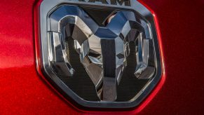The chrome logo on the tailgate of a Ram pickup truck.