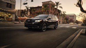 A 2022 Subaru Ascent that could be a a part of the Subaru Ascent recall driving down a city highway.