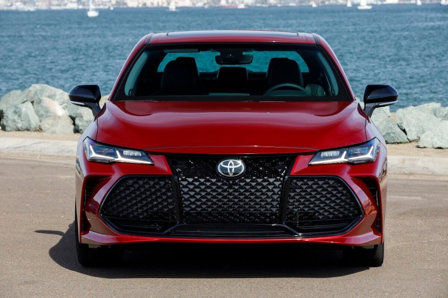 A 2022 Toyota Avalon showcases its red paintwork and big-grille fascia. 